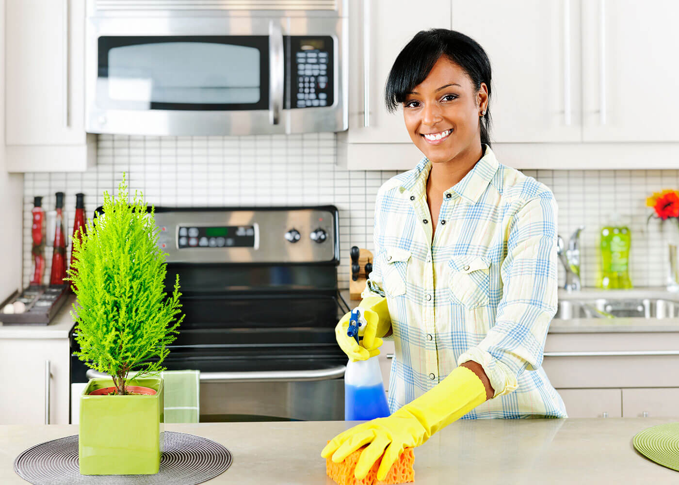 Young-Woman-Cleaning-Kitchen-Hero